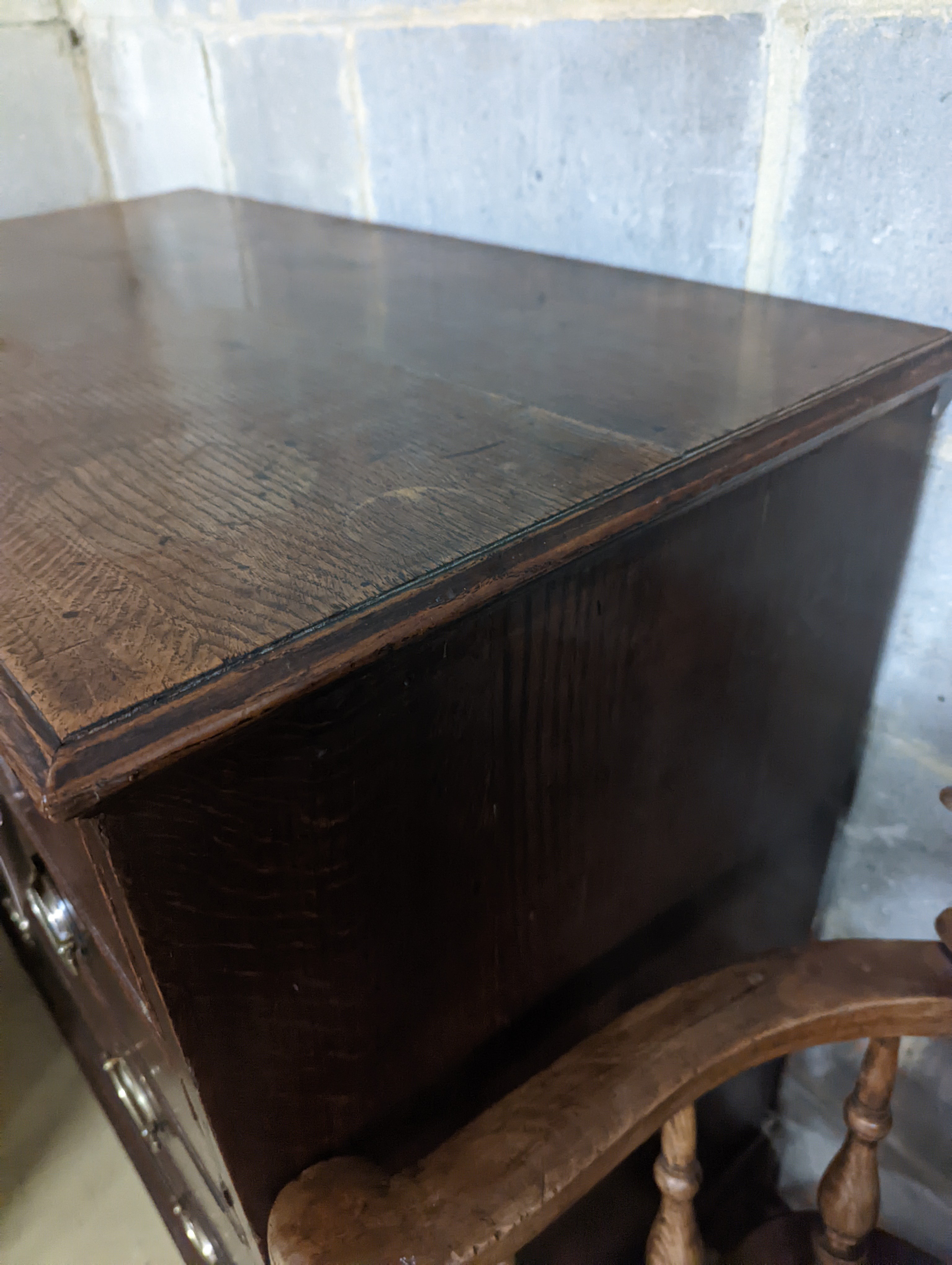 A George III oak chest of two short and three long graduated drawers, . W-94cm, D-51cm, H-99cm.